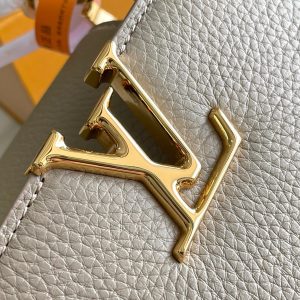 CAPUCINES BB 27 DARK BEIGE TAURILLON GOLD HARDWARE